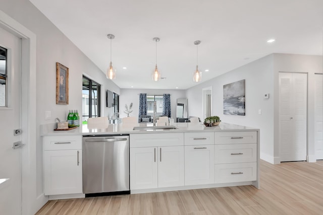 kitchen with white cabinets, sink, decorative light fixtures, dishwasher, and light hardwood / wood-style floors