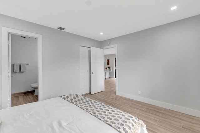 bedroom featuring connected bathroom and a closet