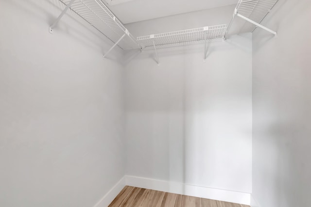 walk in closet featuring hardwood / wood-style floors