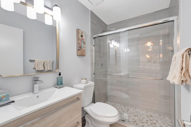 bathroom featuring vanity, toilet, and walk in shower