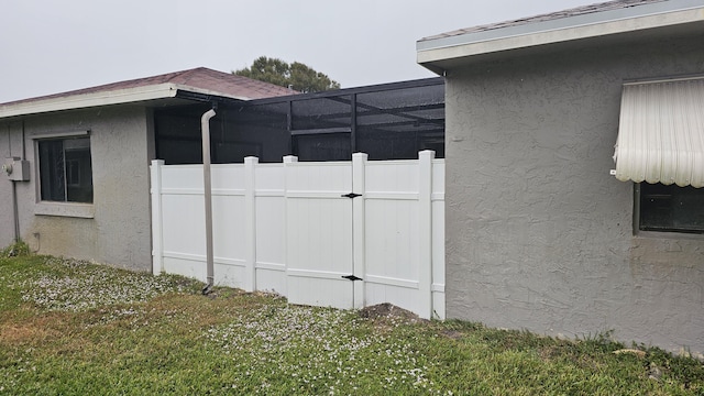 view of side of home with a lawn