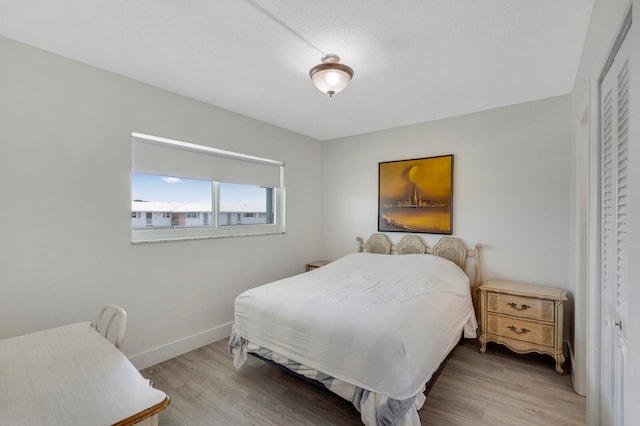 bedroom featuring hardwood / wood-style flooring and a closet