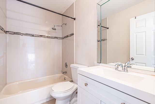 full bathroom featuring vanity, tiled shower / bath combo, and toilet