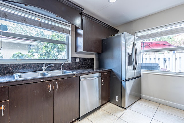 kitchen featuring light tile patterned floors, dark brown cabinetry, sink, and appliances with stainless steel finishes