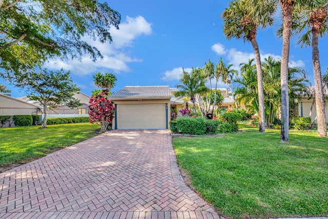 view of front of house with a garage and a front yard