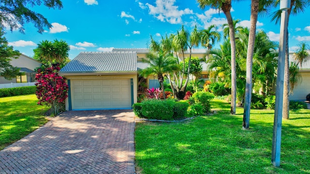 view of front of property featuring a front yard and a garage