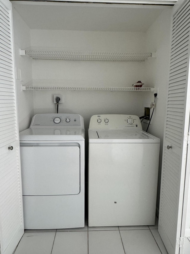 429 N Cypress Dr Unit C, Tequesta, FL 33469 - laundry room featuring washing machine and clothes dryer and light tile patterned flooring