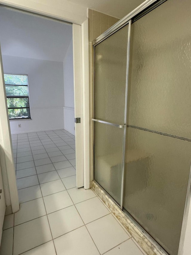 bathroom with tile patterned floors and a shower with shower door