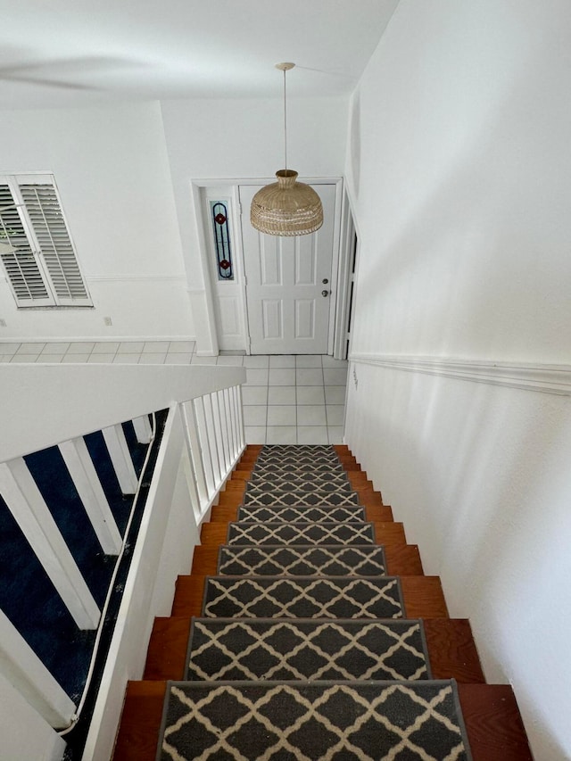 staircase featuring tile patterned flooring