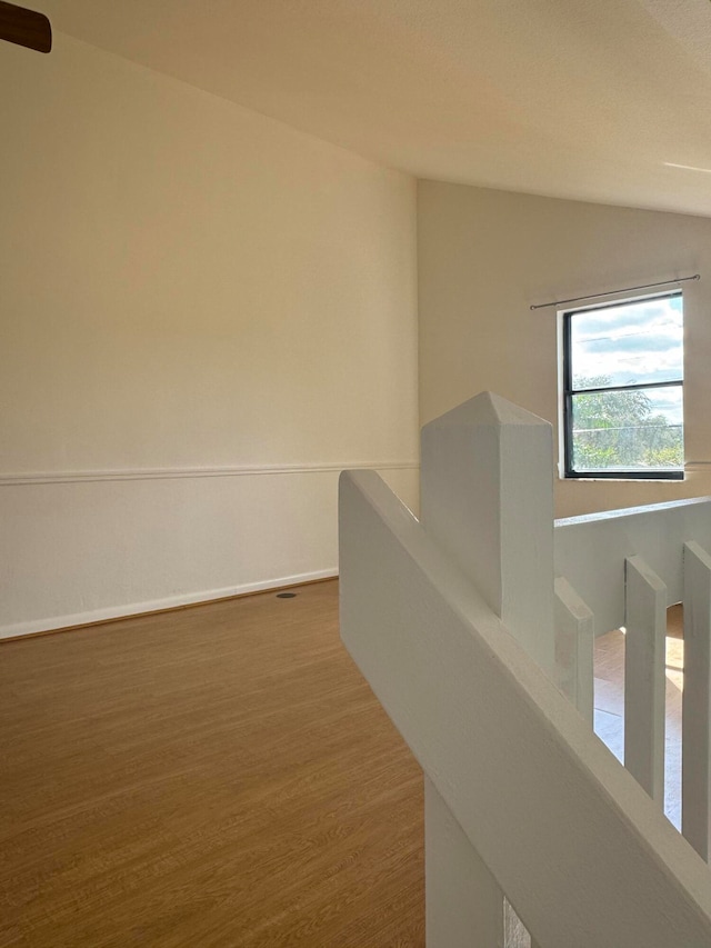 hall with hardwood / wood-style floors and lofted ceiling