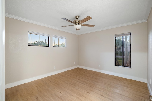 unfurnished room with crown molding, plenty of natural light, ceiling fan, and light hardwood / wood-style flooring