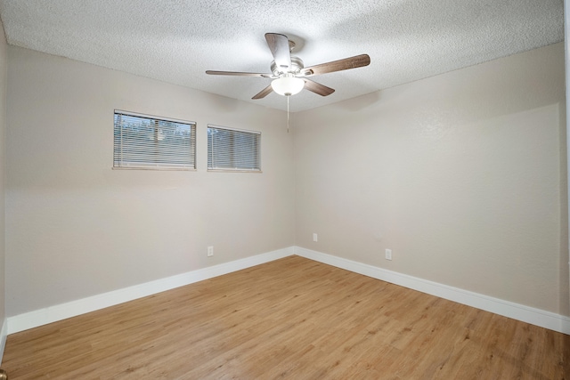 spare room with ceiling fan, wood-type flooring, and a textured ceiling