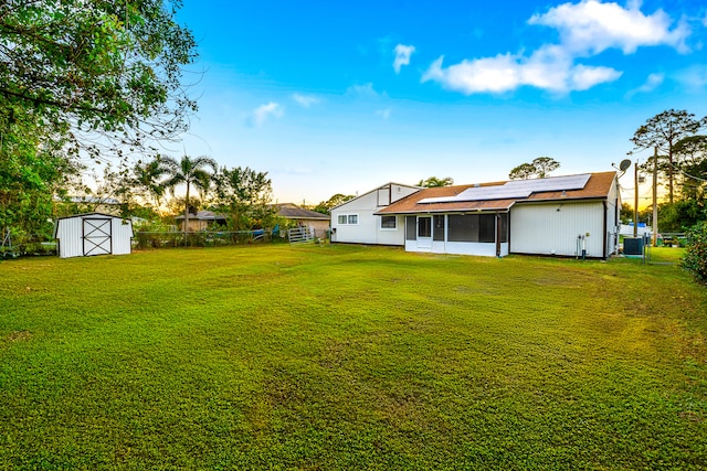 view of yard with a storage shed and a sunroom