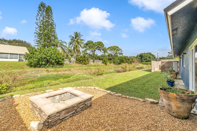 view of yard with an outdoor fire pit