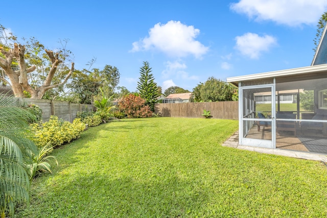 view of yard with a sunroom