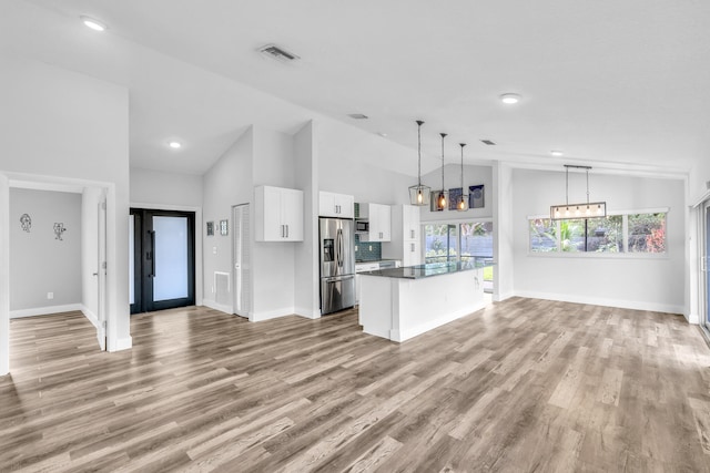 kitchen featuring white cabinets, pendant lighting, light hardwood / wood-style floors, and stainless steel appliances