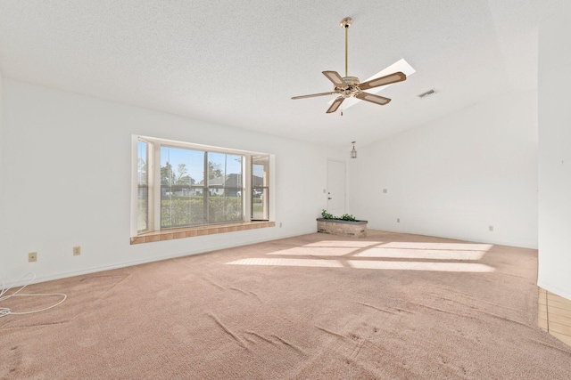 unfurnished room featuring carpet, ceiling fan, a textured ceiling, and vaulted ceiling