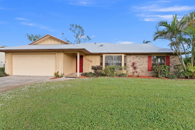 single story home featuring a garage and a front lawn