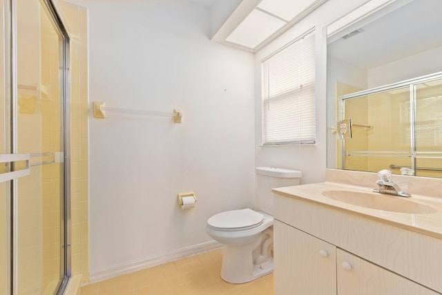 bathroom featuring tile patterned flooring, vanity, toilet, and walk in shower