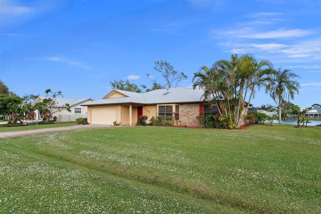 single story home featuring a garage, a water view, and a front lawn