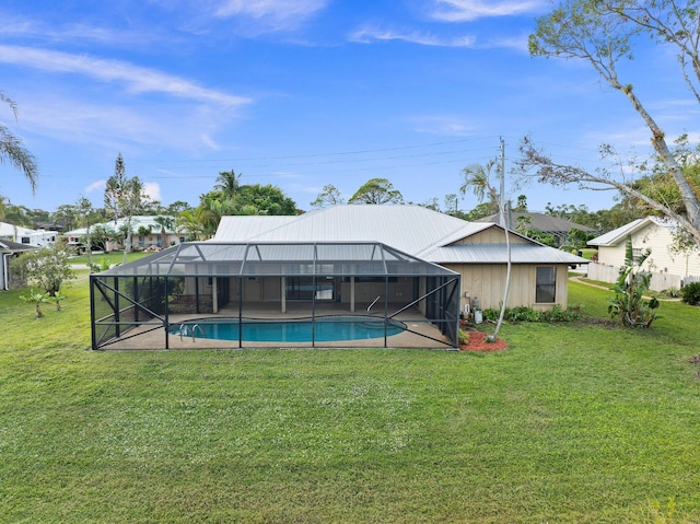 view of pool featuring a lawn and glass enclosure