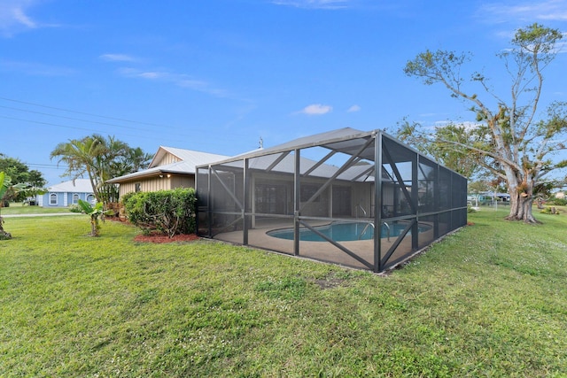 rear view of property with a lawn and glass enclosure