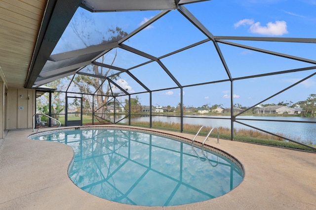 view of swimming pool featuring a lanai, a water view, and a patio