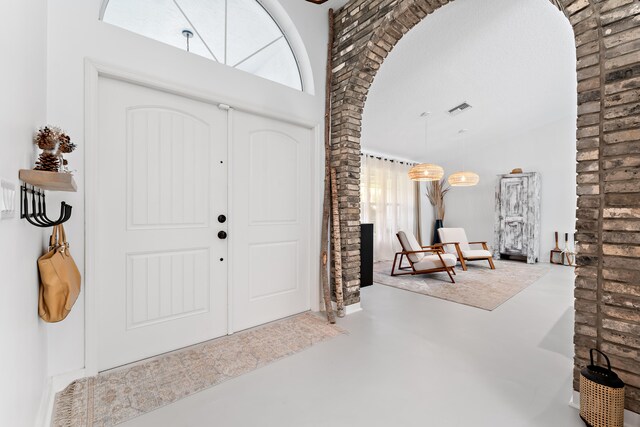 living room featuring concrete floors and vaulted ceiling