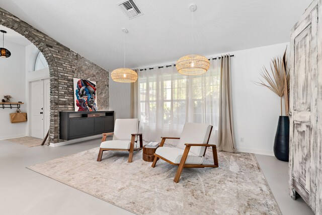 kitchen with a kitchen breakfast bar, hanging light fixtures, an island with sink, stainless steel appliances, and white cabinetry