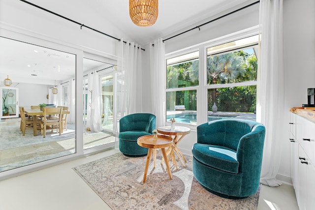 sitting room with concrete floors and vaulted ceiling