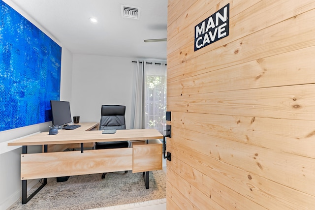 home office featuring wood walls