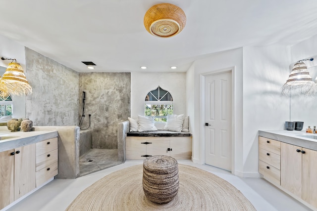 bathroom with vanity, tiled shower, and concrete floors