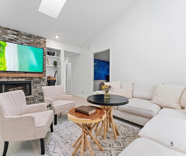 living room with lofted ceiling with skylight, a brick fireplace, and built in shelves