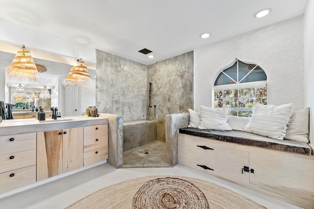 bathroom with vanity and a tile shower