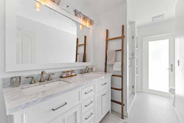 bathroom featuring walk in shower and vanity