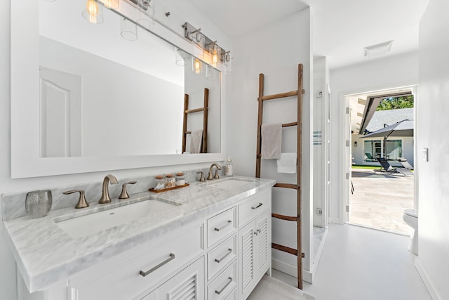 bathroom featuring concrete floors and vanity