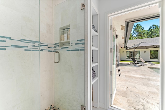 bathroom featuring a shower with door