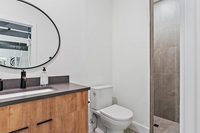 bathroom with tile patterned flooring, a shower, vanity, and toilet