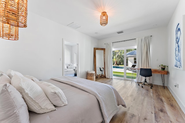 bedroom featuring access to exterior and light wood-type flooring