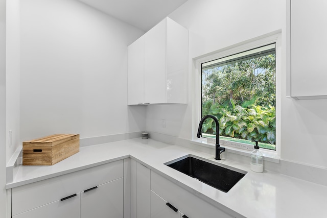 kitchen with sink and white cabinets