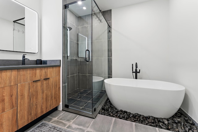 bathroom featuring vanity and independent shower and bath