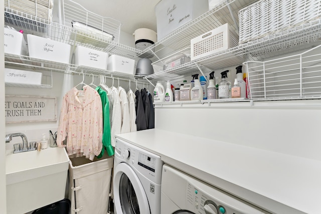 laundry area with separate washer and dryer and sink