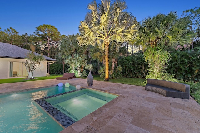 view of swimming pool with an in ground hot tub, a yard, and a patio