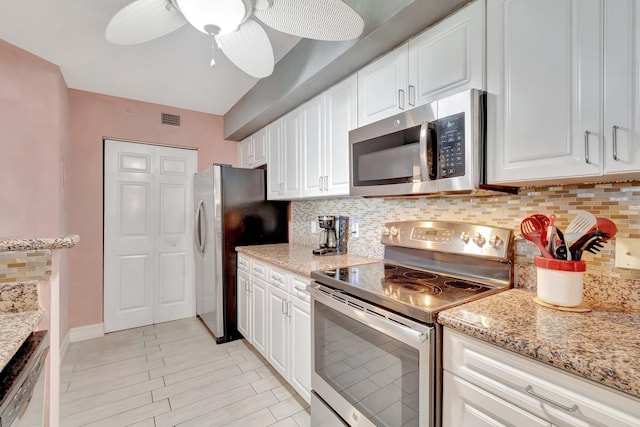 kitchen with decorative backsplash, white cabinetry, ceiling fan, and stainless steel appliances