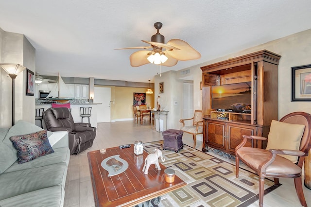 living room featuring light hardwood / wood-style flooring and ceiling fan