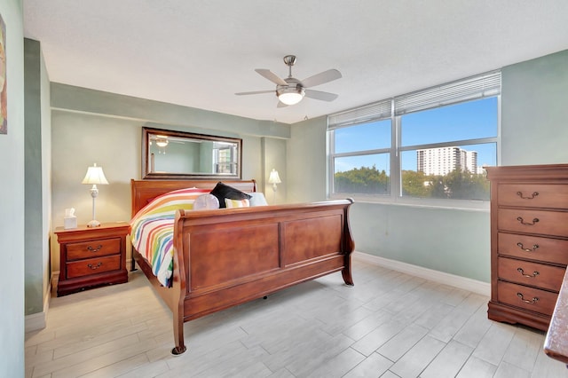 bedroom with ceiling fan and light wood-type flooring