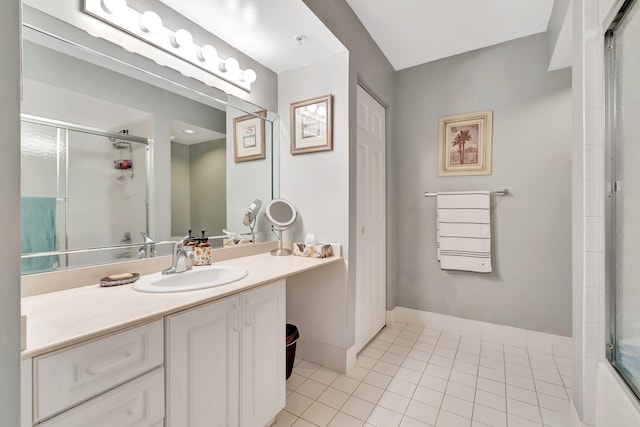 bathroom featuring tile patterned flooring, vanity, and shower / bath combination with glass door