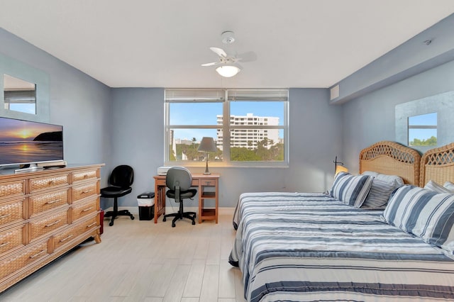 bedroom with ceiling fan and light hardwood / wood-style flooring