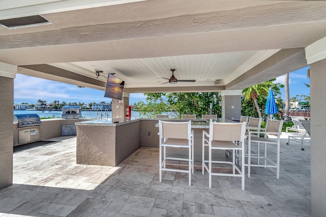 view of patio featuring ceiling fan, a grill, and an outdoor bar