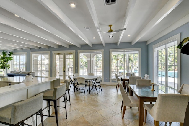 dining area featuring ceiling fan, a healthy amount of sunlight, and beam ceiling